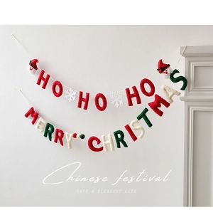 Detail of wool felt Merry Christmas and HO HO HO banner with Santa and snowflake accents