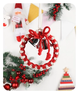 Close-up of handmade woven Christmas wreath with red bow and silver bells ornament
