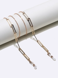 Detail of gold rectangular link chain showing anti-slip silicone loops and metal texture