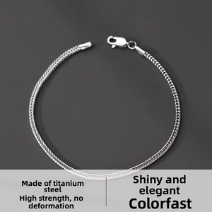 Macro shot of silver woven titanium steel bracelet showing the durable lobster clasp