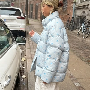 Floral print hooded puffer jacket in light blue styled with a white lace dress