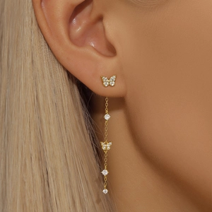 Macro shot of S925 silver butterfly earrings with long tassels and sparkling zircon stones