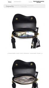 Detailed view of black saddle bag interior structure and capacity with silk scarf detail