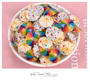 Macro view of colorful miniature umbrella charms for dollhouse DIY jewelry accessories
