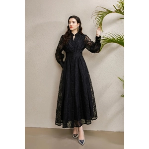 Elegant black V-neck lace dress with lantern sleeves and flared hem in a studio setting