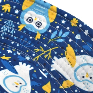Detailed macro view of high-quality sewing lines on penguin pattern bucket hat brim