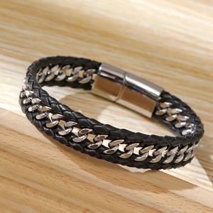 Macro view of braided black microfiber leather with silver stainless steel Cuban chain link