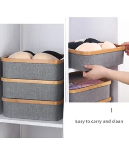 Detail of grey fabric organizer box with wooden frame for bras and underwear storage