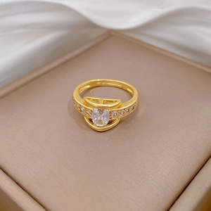 Close-up of golden marquise cut ring with white stones on a jewelry box display