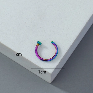 Macro shot of rainbow-colored C-shaped fake nose ring with 1cm diameter measurement