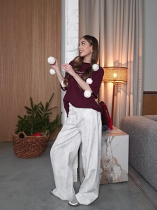 Women's burgundy t-shirt with DEPART print and white wide-leg pants lifestyle set