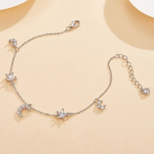 Detail shot of S925 sterling silver star and moon charm bracelet with cubic zirconia