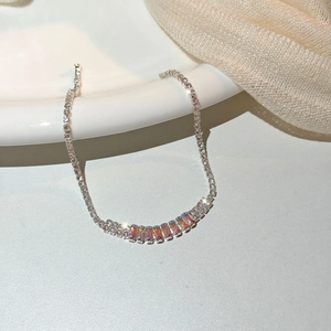 Macro view of silver chain bracelet featuring a rainbow gradient rectangular zircon stone