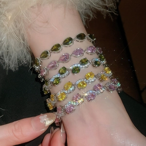 Macro view of crystal teardrop bracelets featuring colorful zircons and refined metal settings