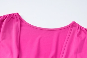 Detail of the high-quality round neckline and precision stitching on the rose red dress