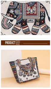 Detail of ethnic canvas tote bag with elephant embroidery and colorful striped handles