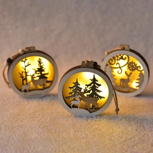 Set of three wooden Christmas ornaments with warm LED lights and reindeer carving