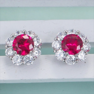 Classic silver halo stud earrings featuring central red gemstone and clear accents
