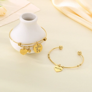 Detail of adjustable gold bracelets set with Love and Mom heart charms for Mother's Day gift