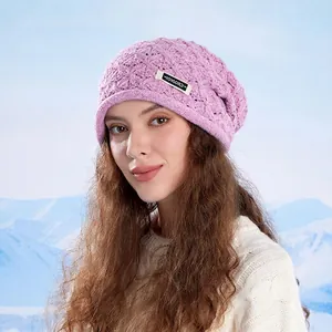 Purple cable knit beanie for women with warm ear protection in winter snow background