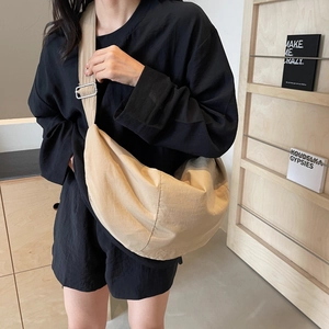 Large beige nylon crescent crossbody bag with adjustable strap for casual daily use
