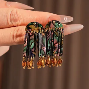 Bohemian tassel earrings with colorful shell pattern and gold beads for a vintage ethnic style