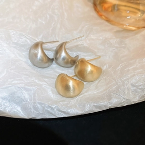 Macro detail of square heart C-shaped stud earrings with matte brushed metallic finish