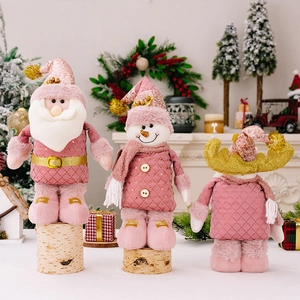 Detailed view of pink plush Christmas figurines including Santa, Snowman and Reindeer