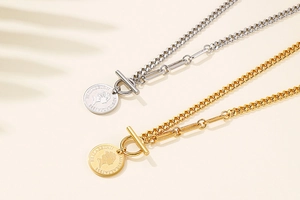 Detailed macro view of gold and silver coin pendants with Queen Elizabeth II engraving