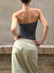 Sleek dark grey tube top and khaki maxi skirt street style outfit view from behind