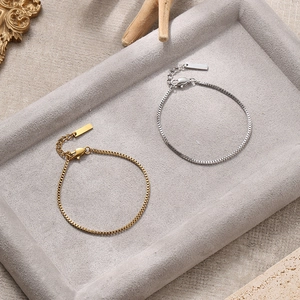 Men's trendy stainless steel box chain bracelet in gold and silver finish on display