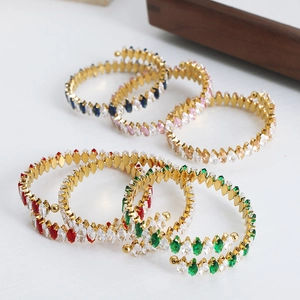 Luxe gold spiral bracelet featuring colorful marquise-cut cubic zirconia in vibrant shades