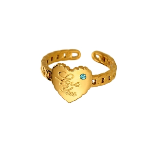 Detail of gold-plated heart ring with blue stone and Love You engraving