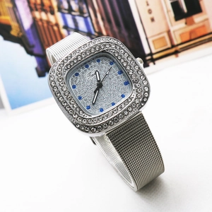 Detail of square alloy watch with rhinestone bezel and silver Milanese mesh strap