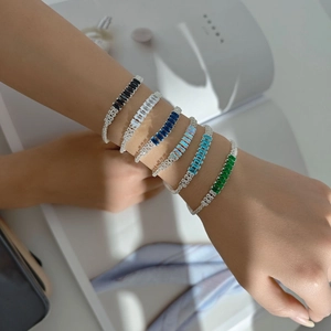 Macro shot of silver bracelets featuring rectangular colored zirconia in various hues