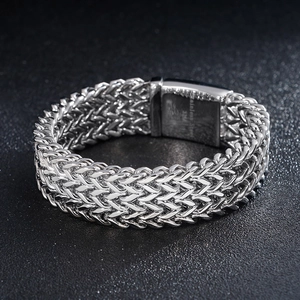 Detail of 316L stainless steel woven chain bracelet with engraved metal buckle clasp
