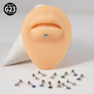 Detail of G23 titanium labret studs with colorful opal stones on a lip model