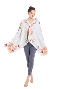Detail view of the soft microfiber beach towel draped over a woman in floral print