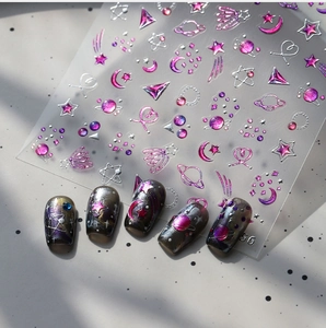 Detailed view of 3D embossed moon and star nail art stickers on cosmic base