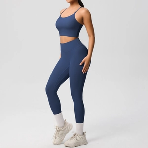 Detail of dark blue high-waisted yoga leggings and cross-strap sports bra set
