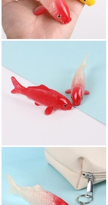 Detailed view of mini PVC koi fish charms in red and pink with metal keyrings