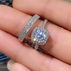 Exquisite two-piece wedding ring set with halo round zircon and shimmering pavé band