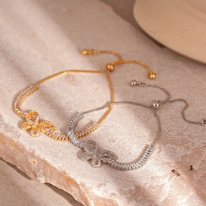 Elegante bracciale a farfalla con zirconi in oro e argento e chiusura regolabile bolo