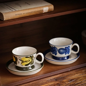 Vintage hand-painted ceramic coffee cup and saucer set with colorful fruit pattern