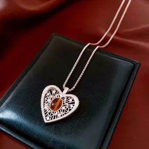 Vintage rose gold hollow heart necklace featuring tiger eye stone and zircon accents