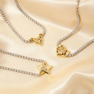 Golden geometric chain necklace with zircon cross pendants on champagne silk background