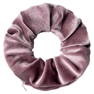 Close-up of a dusty pink velvet scrunchie with a ribbed texture and zipper detail