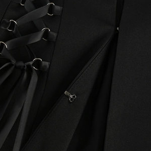 Macro detail of black lace-up waist dress with satin ties and silver metal eyelets