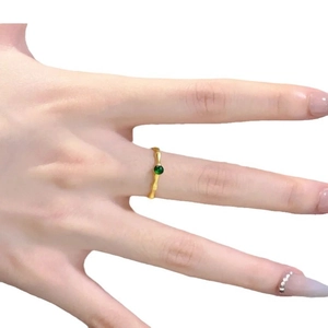 Bamboo style open ring with green gemstone setting in a minimalist gold finish design