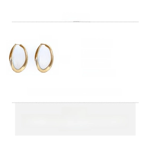 Detailed view of large golden oval earrings with dimensions 6.7x4cm and copper material